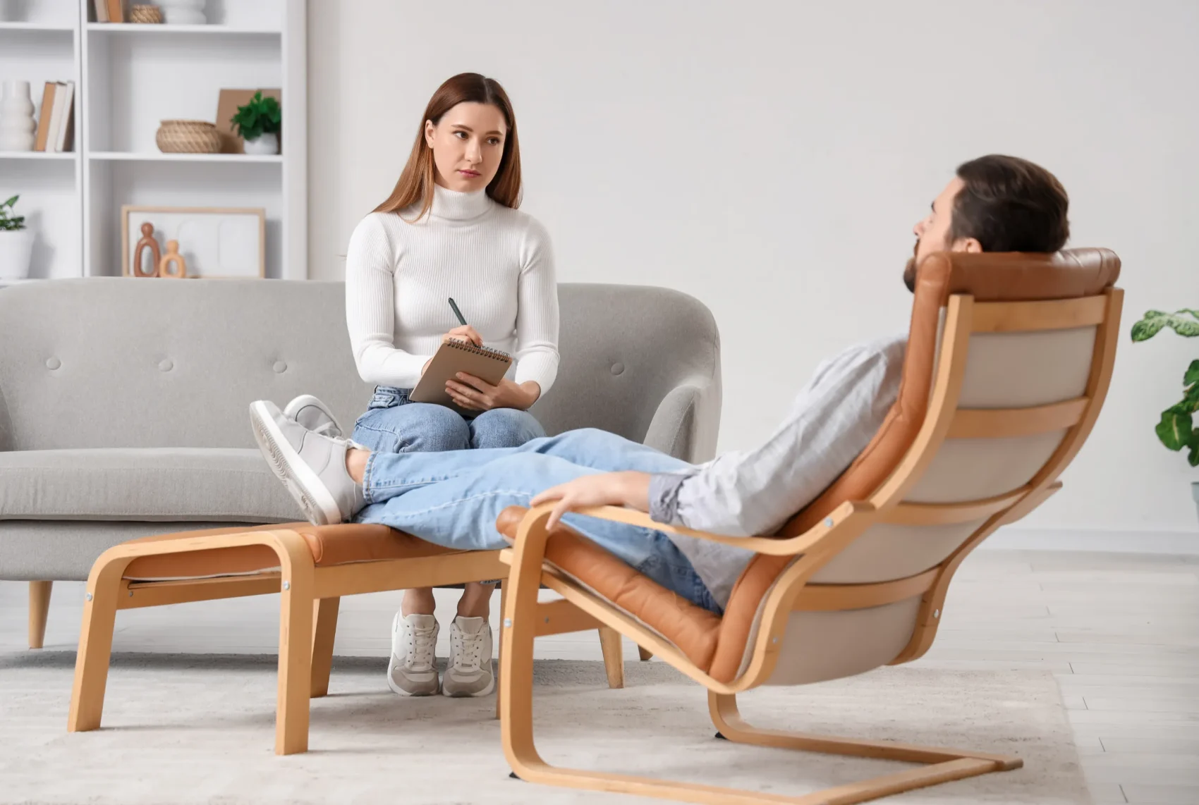 A practitioner and client in conversation, with questions discussed openly before a session begins
